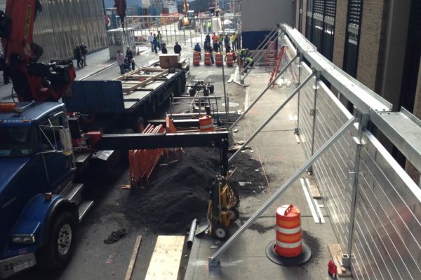 Unlike a typical installation of the Invisible Flood Control Wall, the project at 140 West demanded a free-standing design. The wall is not anchored into a foundation. Rather, massive steel beams on the top and bottom of the flood wall posts weight the system into place.