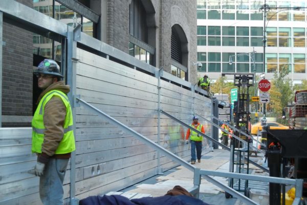 The flood wall system completely surrounds 140 West on all four sides, about 1000' linear feet.. The typical height is about 9'. The diagonal members are wind struts that keep the wall in place during erection.